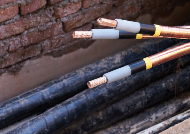 Cables near a brick wall