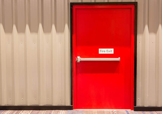 Red door with fire exit sign