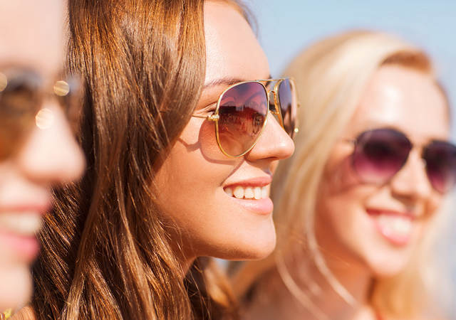 Three women wearing sunglasses