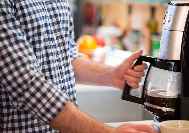 Consumer using a coffee maker