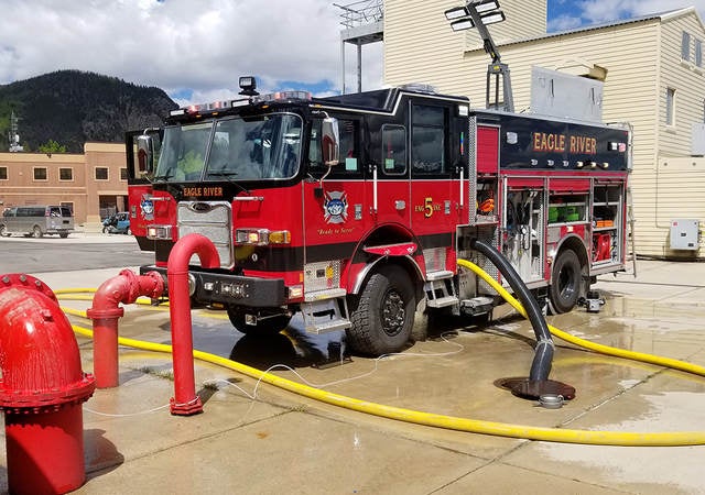 A parked fire truck receiving maintenance.