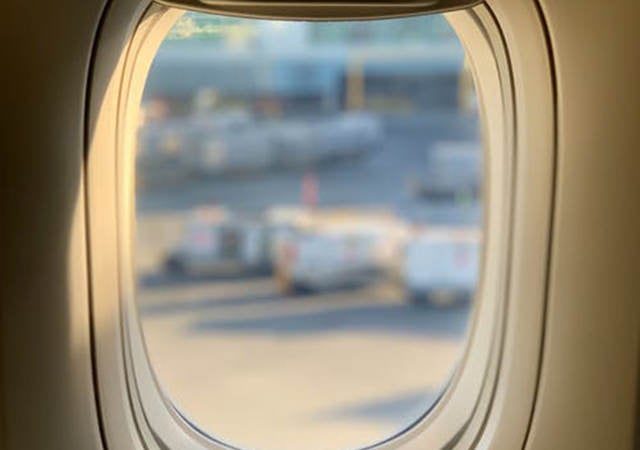 Looking out an airplane window over a tarmac