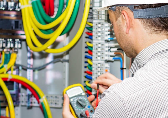 Electrical engineer working in electrical cabinet