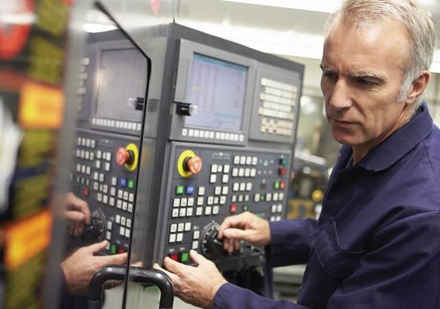 Technician working on an industrial control panel