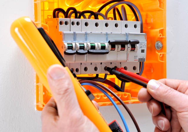 Electrician technician at work on a residential electric panel