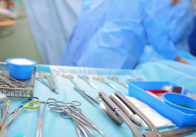 Sterile surgical equipment laid out on a tray in an operating room 