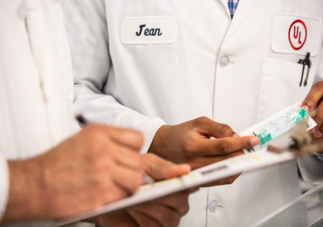 Men in a labcoat doing testing