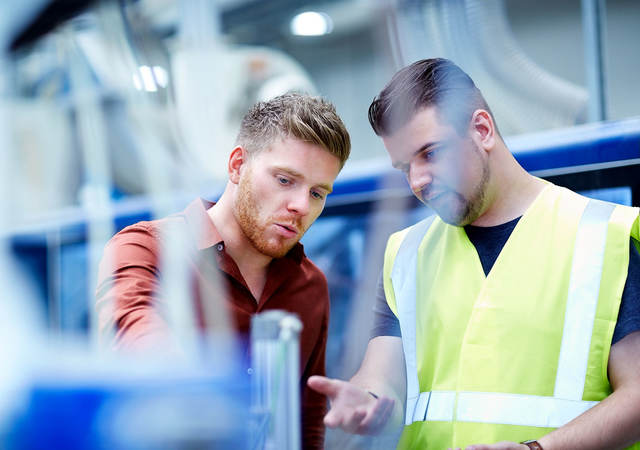 two young men conducting cable inspection for compliance