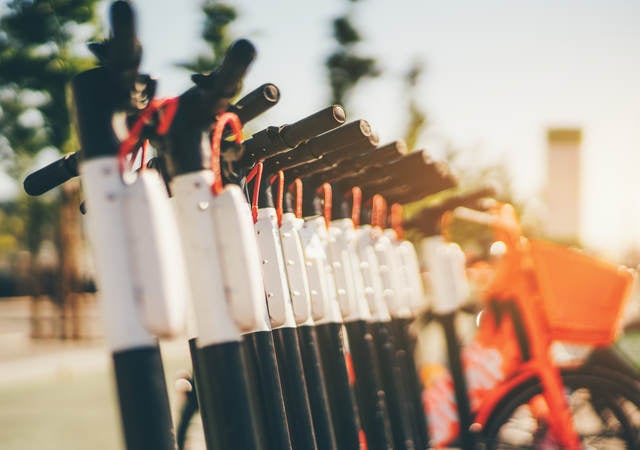 A row of outdoor scooters