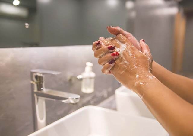 hands washing in a sink