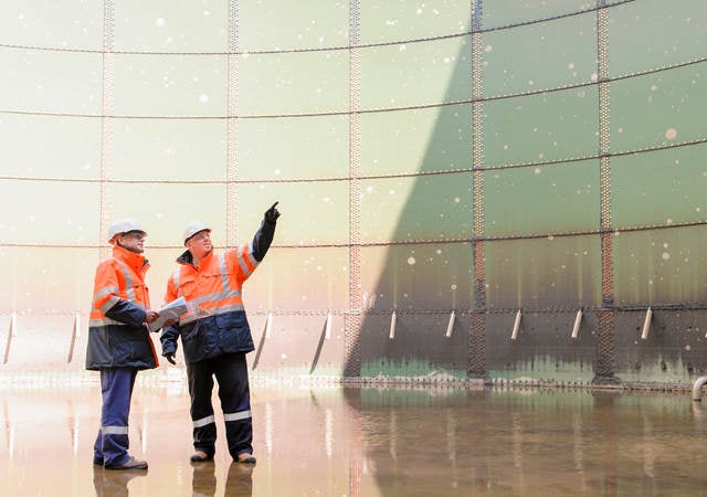 Technicians examining fuel storage tank