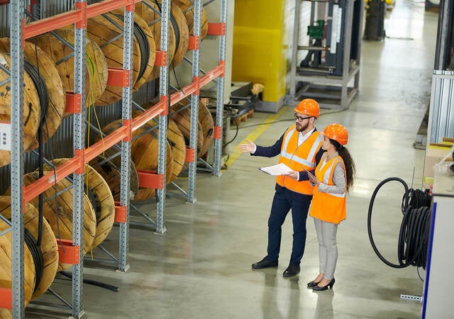 Workers auditing a warehouse