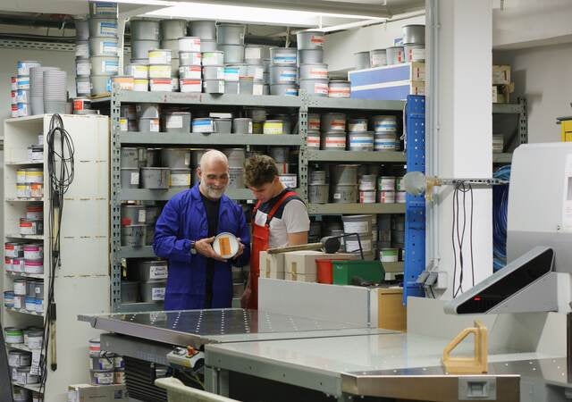 Workers looking at a paint can