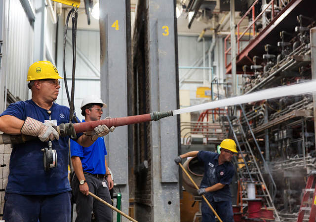 Photo of men in hardhats testing fire doors 