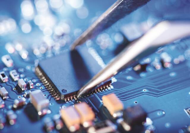 Tweezers over a circuit board