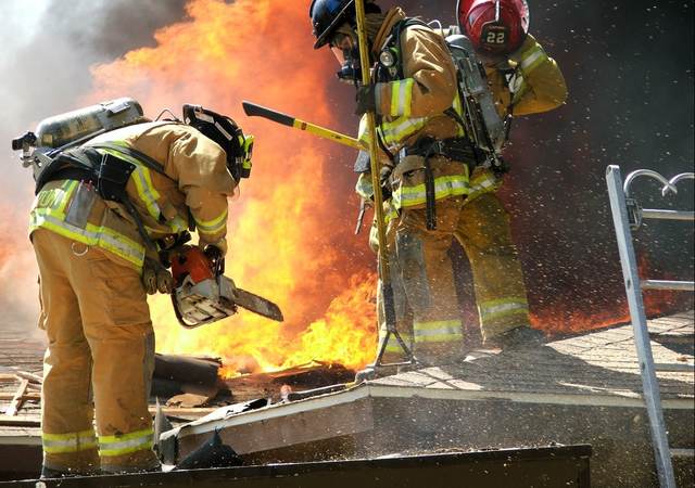 Firefighters working on roof