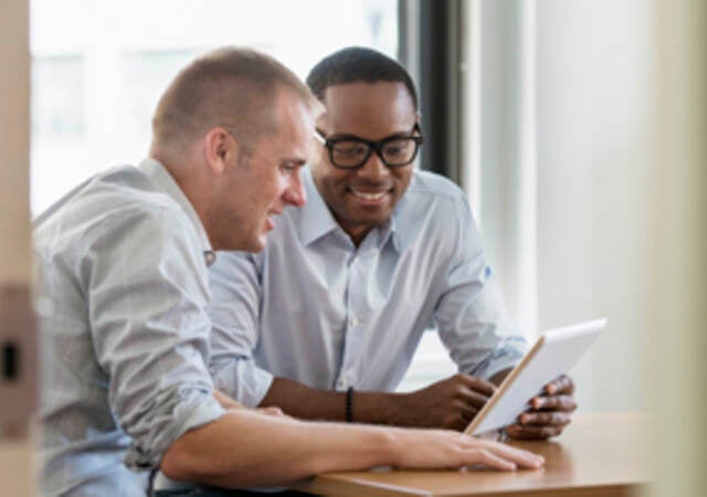 business men looking at tablet