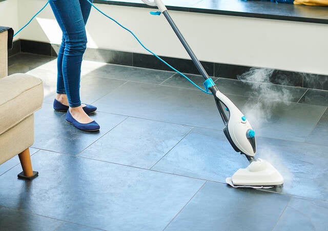 Steam cleaner mop cleaning a floor