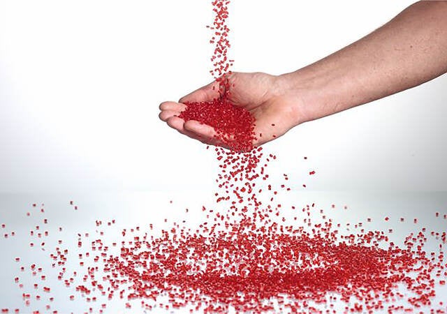 Hand catching plastic pellets