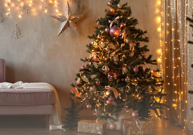 A living room with pre-lit Christmas tree and other lit decorations