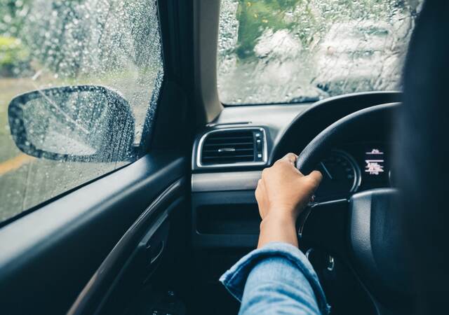 Man driving car in rain