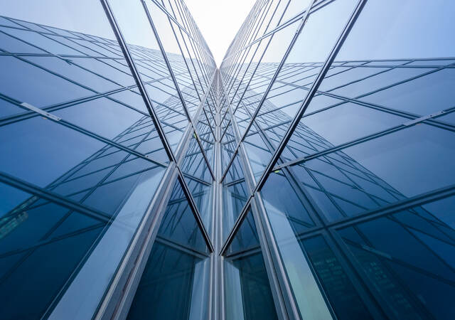 Modern blue glass building mirror reflections