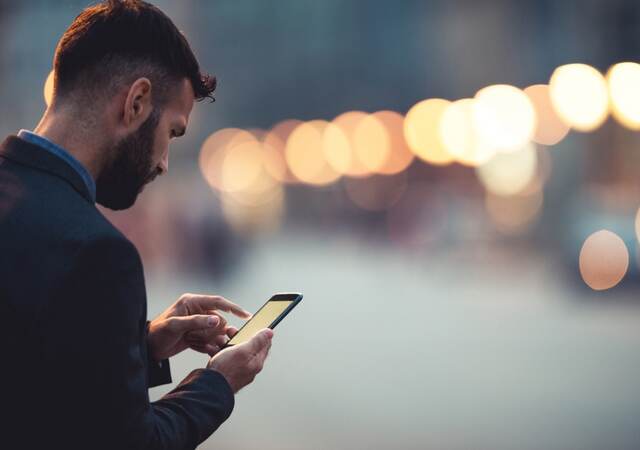 man checking smartphone