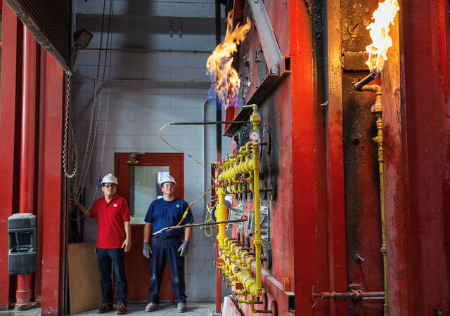 Two engineers performing a column fire test