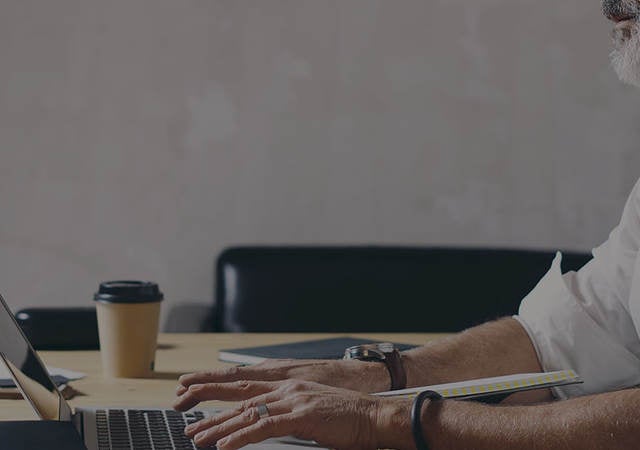 Man sitting in front of computer at a desk