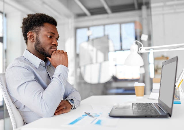 Man sitting in front of computer doing online training