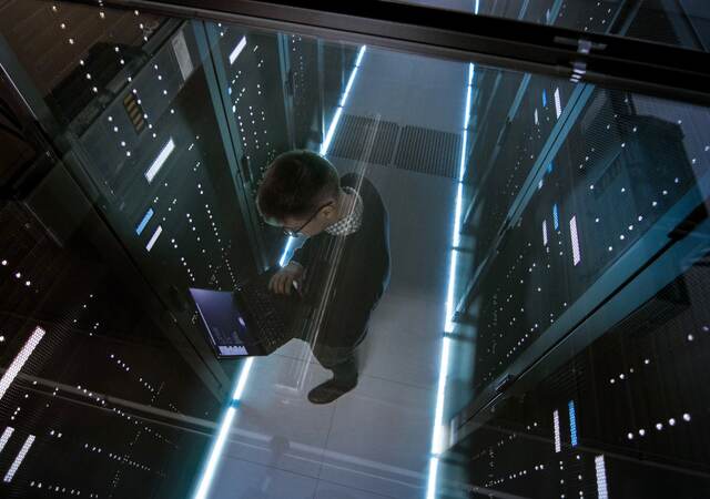 Top down view of man working in a data center 