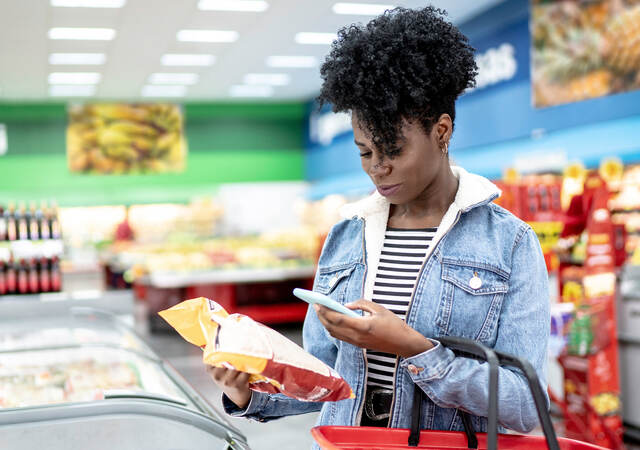 Woman scanning a label at the grocery store