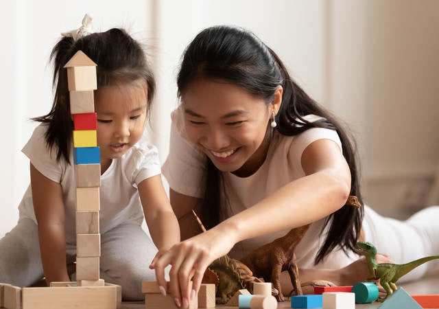 Mother and child playing with toys together