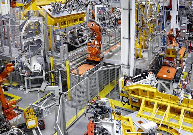 Robots putting cars together in a factory