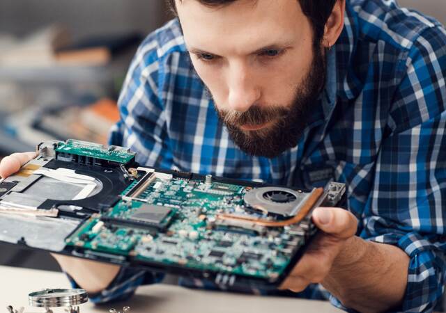 Engineer studying computer motherboard