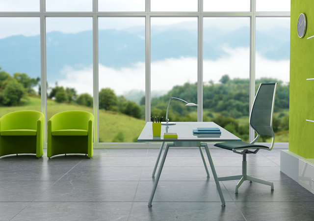 Glass desk with chair and view of the countryside through corporate windows.