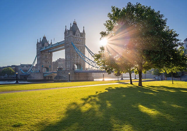 View of London bridge with sun rays in the background.