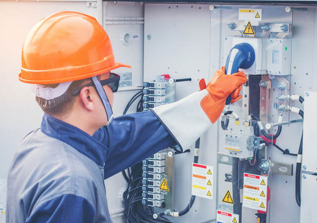 Engineer working on equipment and performing maintenance in a solar power plant