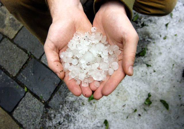 Two hands holding hail stones