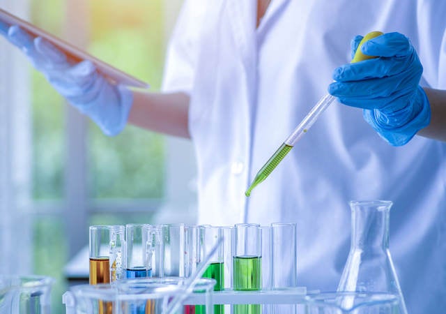 Scientist working in a chemical laboratory and using test tubes