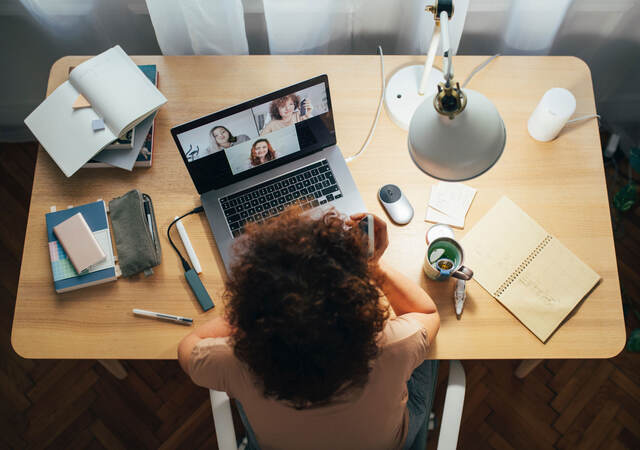 Woman on laptop learning and interacting with others