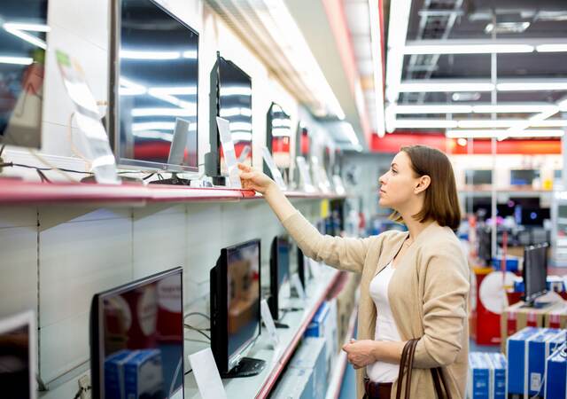 woman buying a TV in a retail store