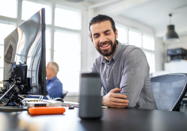 businessman using digital speaker at office