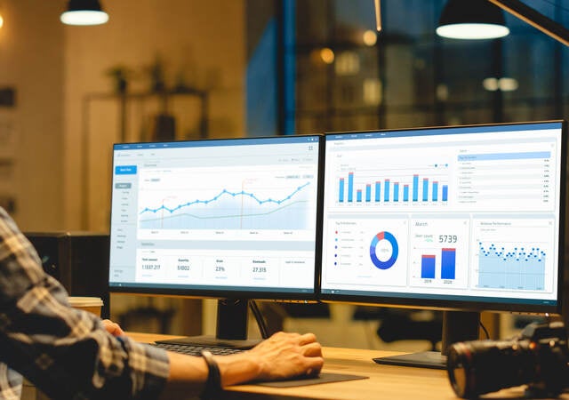 two monitors showing graphs and data