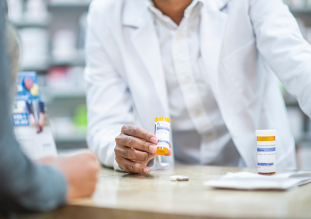 Pharmacist speaks with patient about prescription medication