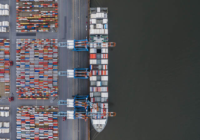 Container ship docked in port as seen from above