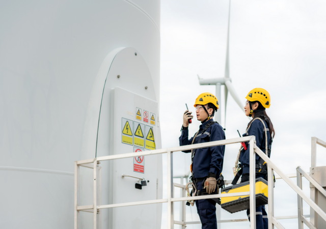 Employees performing a wind turbine inspection