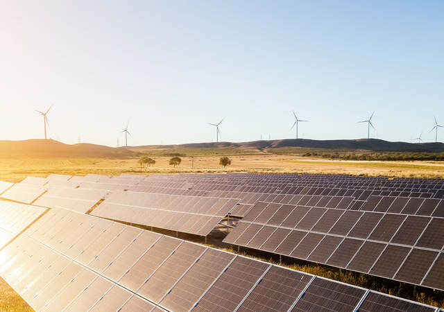 Sunrise on a solar and wind farm