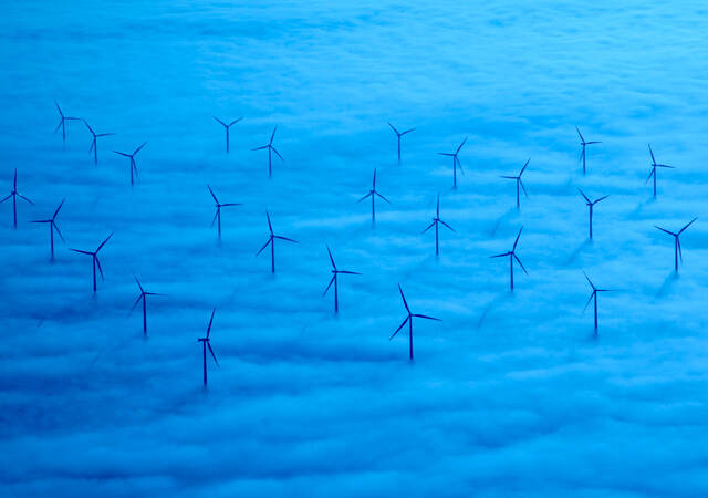 A wind farm in a sea of blue clouds