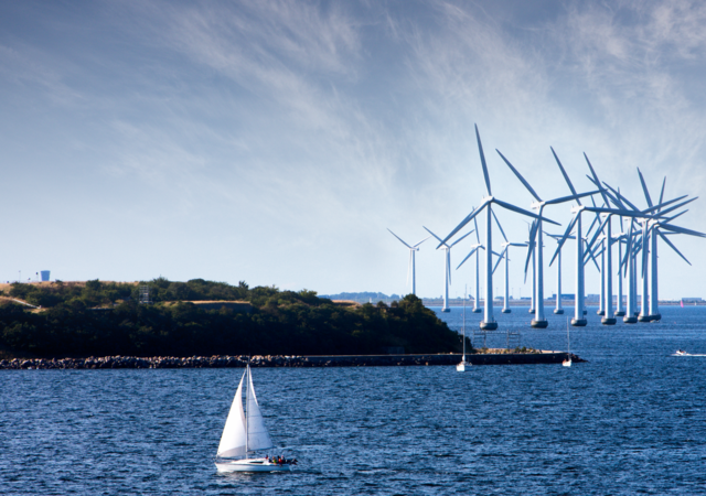 Wind turbines at sea with boat